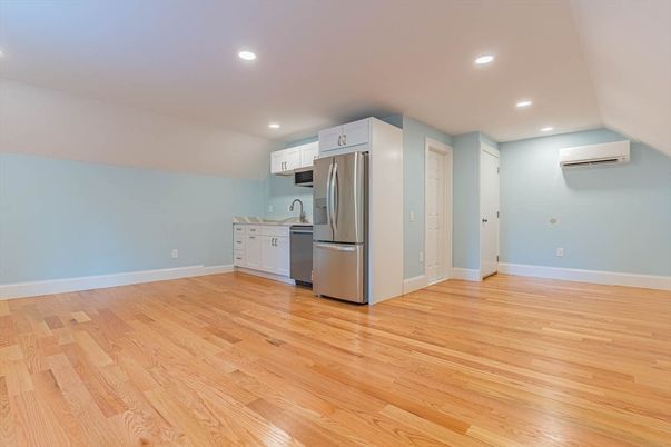 Empty room, Interior, Kitchen, Recessed Lighting, Stainless Steel Appliances, Wood Texture Flooring