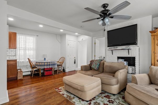 Dining room, Fireplace, Interior, Living room, Recessed Lighting, Wood Texture Flooring