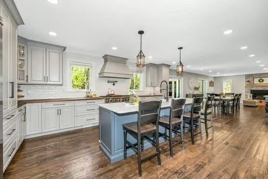 Dining room, Fireplace, Interior, Kitchen, Pendant Lights, Recessed Lighting, Stainless Steel Appliances, Stone Walls, Wood Texture Flooring