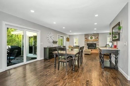 Dining room, Fireplace, Interior, Living room, Recessed Lighting, Stone Walls, Wood Texture Flooring