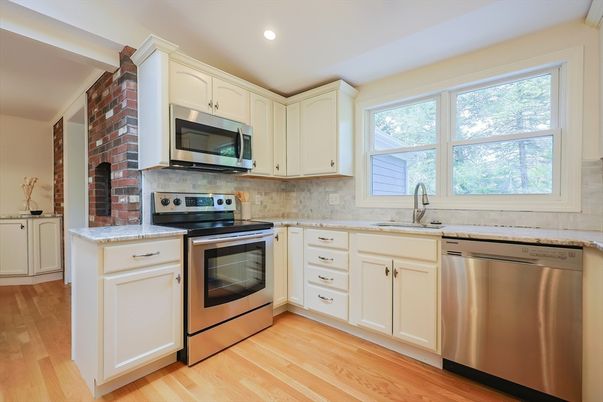Fireplace, Interior, Kitchen, Recessed Lighting, Stainless Steel Appliances, Stone Walls, Wood Texture Flooring