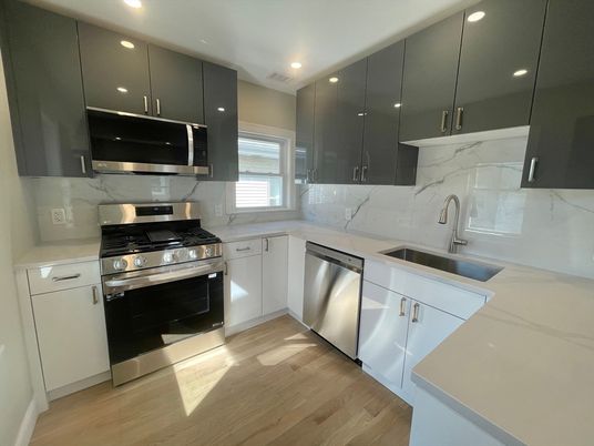Interior, Kitchen, Marble Walls, Recessed Lighting, Stainless Steel Appliances, Wood Texture Flooring