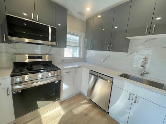 Interior, Kitchen, Marble Walls, Recessed Lighting, Stainless Steel Appliances, Wood Texture Flooring