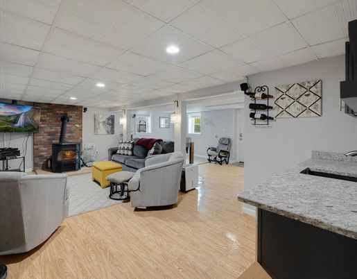 Fireplace, Interior, Living room, Recessed Lighting, Stone Walls, Wood Texture Flooring
