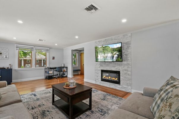 Fireplace, Interior, Living room, Recessed Lighting, Stone Walls, Wood Texture Flooring