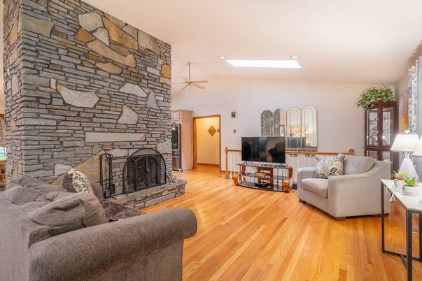 Fireplace, Interior, Living room, Recessed Lighting, Stone Walls, Wood Texture Flooring