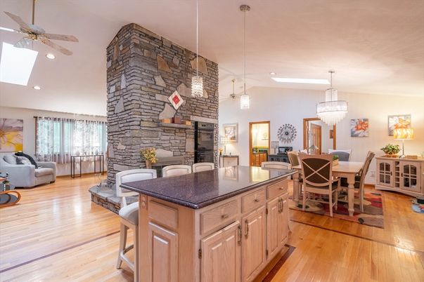 Chandelier, Dining room, Fireplace, Interior, Pendant Lights, Recessed Lighting, Stone Walls, Wood Texture Flooring