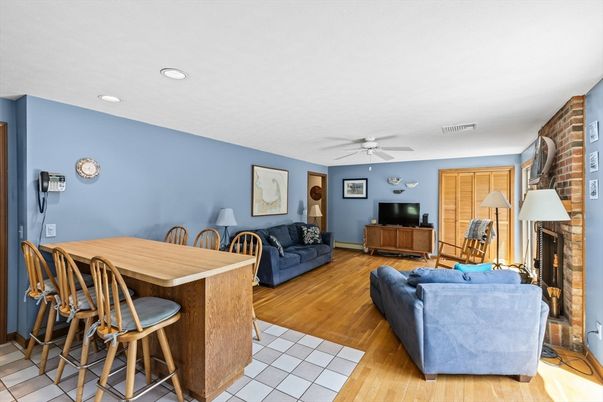 Dining room, Fireplace, Interior, Living room, Recessed Lighting, Stone Walls, Wood Texture Flooring