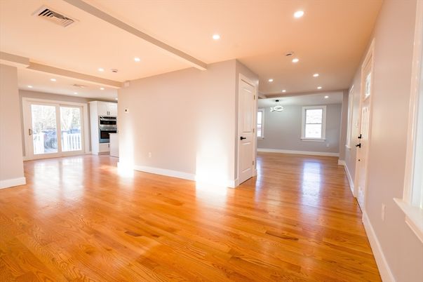 Empty room, Interior, Kitchen, Recessed Lighting, Stainless Steel Appliances, Wood Texture Flooring