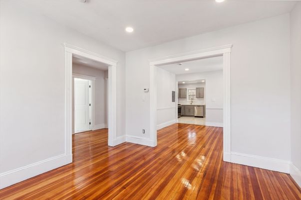 Empty room, Interior, Kitchen, Recessed Lighting, Stainless Steel Appliances, Wood Texture Flooring