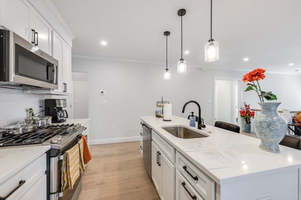 Interior, Kitchen, Pendant Lights, Recessed Lighting, Stainless Steel Appliances, Tile Countertops, Wood Texture Flooring