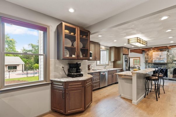 Fireplace, Interior, Kitchen, Recessed Lighting, Stainless Steel Appliances, Stone Walls, Wood Texture Flooring