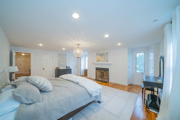 Bedroom, Chandelier, Fireplace, Interior, Recessed Lighting, Wood Texture Flooring