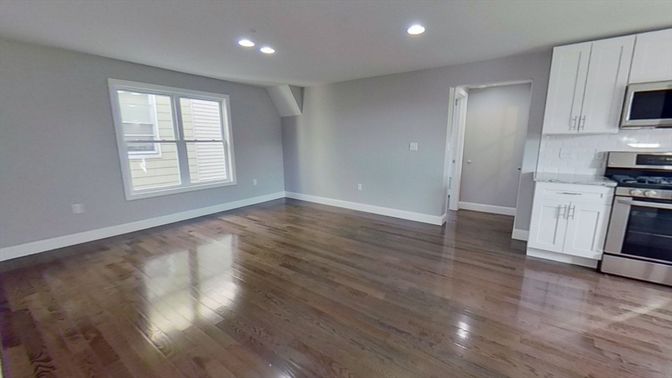 Empty room, Interior, Kitchen, Recessed Lighting, Stainless Steel Appliances, Wood Texture Flooring