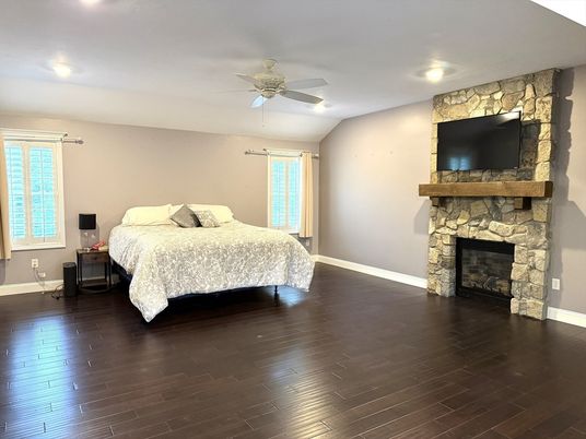 Bedroom, Fireplace, Interior, Recessed Lighting, Stone Walls, Wood Texture Flooring