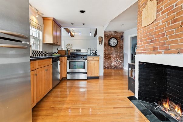 Fireplace, Interior, Kitchen, Pendant Lights, Recessed Lighting, Stainless Steel Appliances, Stone Walls, Wood Texture Flooring