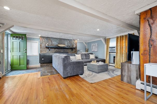 Fireplace, Interior, Living room, Marble Walls, Recessed Lighting, Stone Walls, Wood Texture Flooring