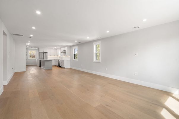 Empty room, Interior, Kitchen, Recessed Lighting, Stainless Steel Appliances, Wood Texture Flooring