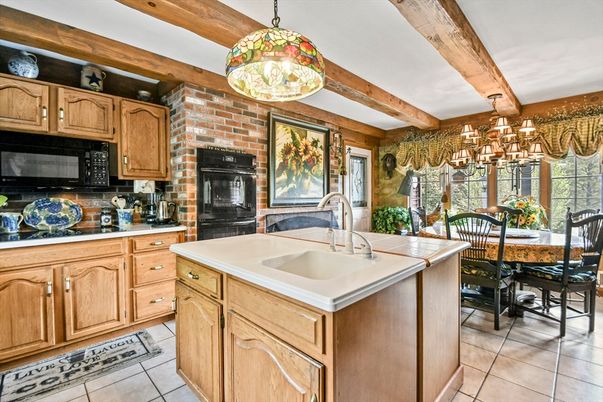Chandelier, Dining room, Fireplace, Interior, Kitchen, Pendant Lights, Stone Walls, Wooden Beams