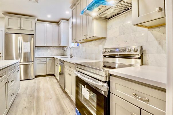 Interior, Kitchen, Marble Walls, Recessed Lighting, Stainless Steel Appliances, Wood Texture Flooring