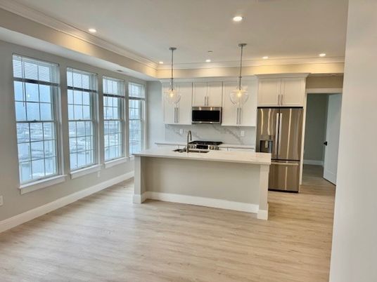 Interior, Kitchen, Marble Walls, Pendant Lights, Recessed Lighting, Stainless Steel Appliances, Wood Texture Flooring
