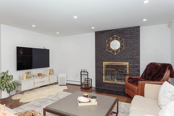 Fireplace, Interior, Living room, Recessed Lighting, Stone Walls, Wood Texture Flooring