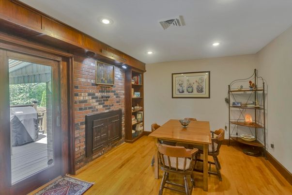 Dining room, Fireplace, Interior, Recessed Lighting, Stone Walls, Wood Texture Flooring