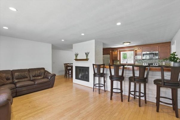 Dining room, Fireplace, Interior, Kitchen, Living room, Recessed Lighting, Stainless Steel Appliances, Wood Texture Flooring