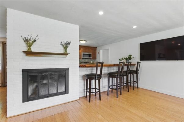 Fireplace, Interior, Kitchen, Recessed Lighting, Stainless Steel Appliances, Stone Walls, Wood Texture Flooring