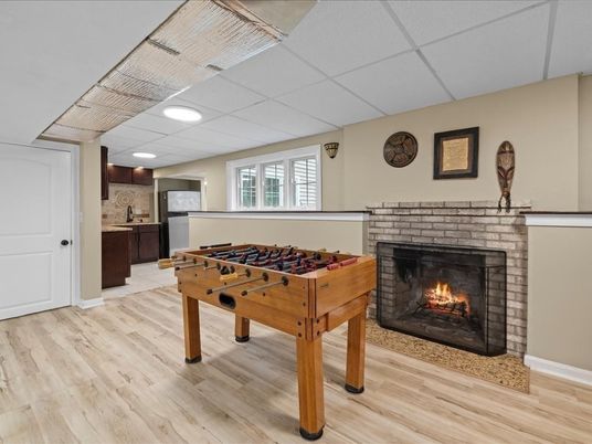 Fireplace, Game Room, Interior, Recessed Lighting, Wood Texture Flooring