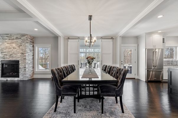 Chandelier, Dining room, Fireplace, Interior, Kitchen, Pendant Lights, Recessed Lighting, Stainless Steel Appliances, Stone Walls, Wood Texture Flooring
