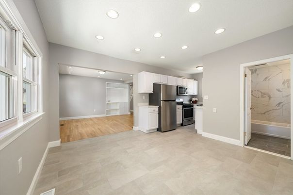 Interior, Kitchen, Marble Walls, Recessed Lighting, Stainless Steel Appliances, Wood Texture Flooring