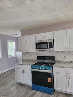 Interior, Kitchen, Marble Walls, Recessed Lighting, Stainless Steel Appliances, Wood Texture Flooring