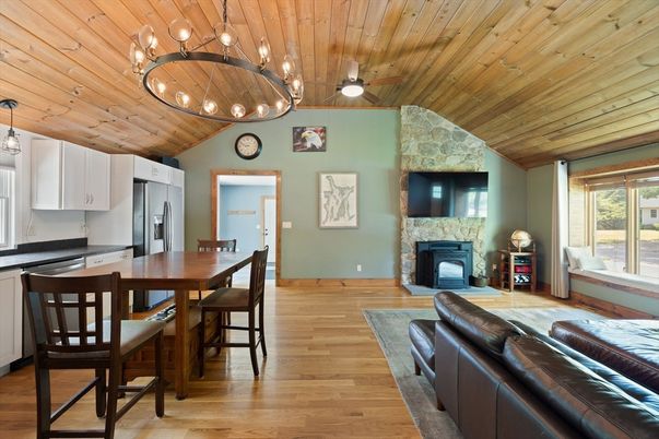 Chandelier, Dining room, Fireplace, Interior, Kitchen, Living room, Pendant Lights, Stone Walls, Wooden Ceilings, Wood Texture Flooring