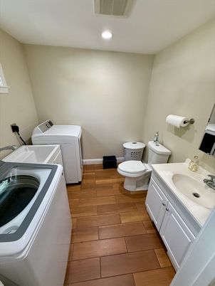 Bathroom, Dual Sink Vanities, Interior, Recessed Lighting, Washer, Wood Texture Flooring