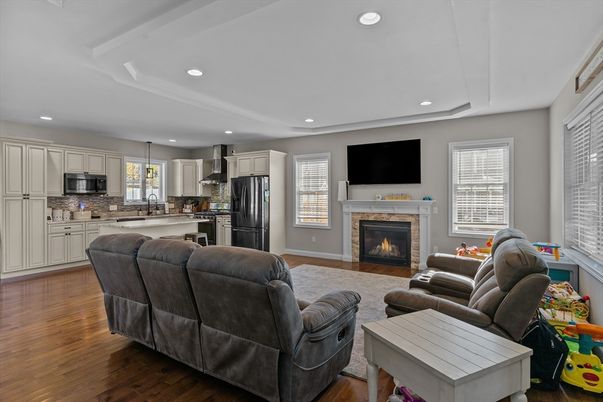 Fireplace, Interior, Kitchen, Living room, Pendant Lights, Recessed Lighting, Stainless Steel Appliances, Wood Texture Flooring