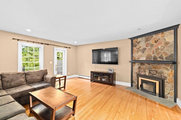 Fireplace, Interior, Living room, Recessed Lighting, Stone Walls, Wood Texture Flooring