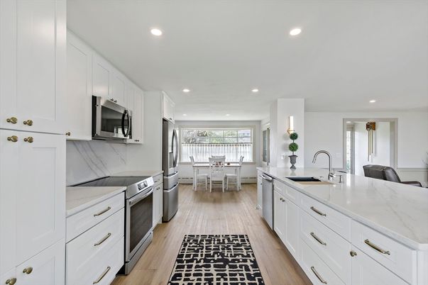 Dining room, Interior, Kitchen, Marble Walls, Recessed Lighting, Stainless Steel Appliances, Wood Texture Flooring