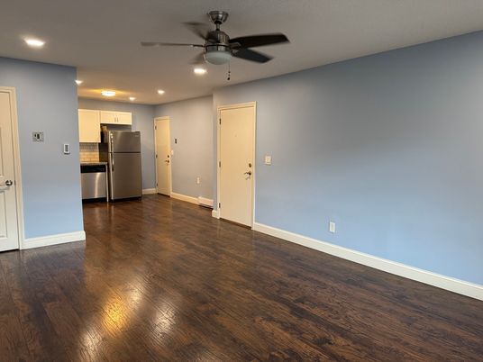 Empty room, Interior, Kitchen, Recessed Lighting, Stainless Steel Appliances, Wood Texture Flooring