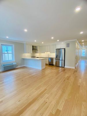 Empty room, Interior, Kitchen, Recessed Lighting, Stainless Steel Appliances, Wood Texture Flooring