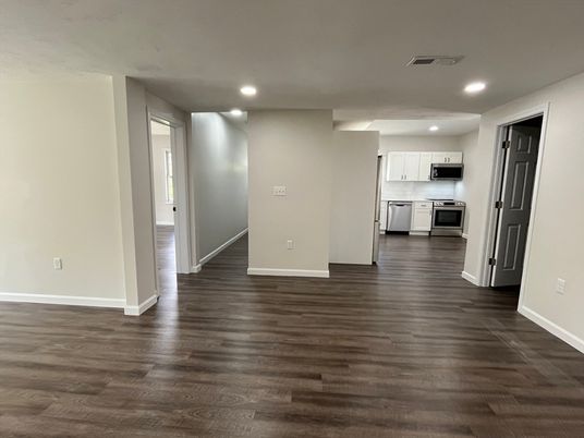 Empty room, Interior, Kitchen, Recessed Lighting, Stainless Steel Appliances, Wood Texture Flooring