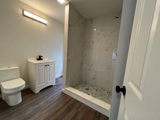Bathroom, Glass Shower, Interior, Marble Walls, Wood Texture Flooring