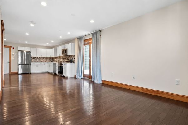 Empty room, Interior, Kitchen, Recessed Lighting, Stainless Steel Appliances, Wood Texture Flooring