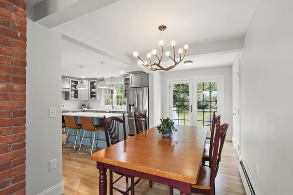 Chandelier, Dining room, Interior, Kitchen, Pendant Lights, Stainless Steel Appliances, Stone Walls, Wood Texture Flooring
