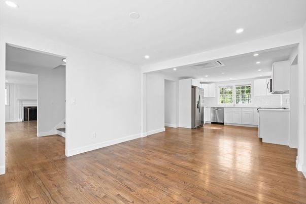 Empty room, Interior, Kitchen, Recessed Lighting, Stainless Steel Appliances, Wood Texture Flooring