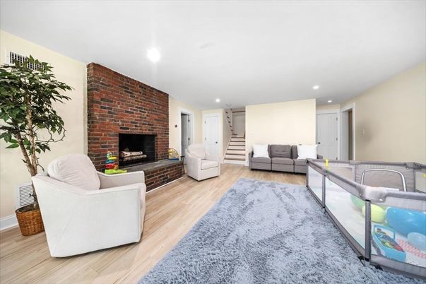 Fireplace, Interior, Living room, Recessed Lighting, Stone Walls, Wood Texture Flooring