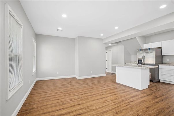 Empty room, Interior, Kitchen, Recessed Lighting, Stainless Steel Appliances, Wood Texture Flooring