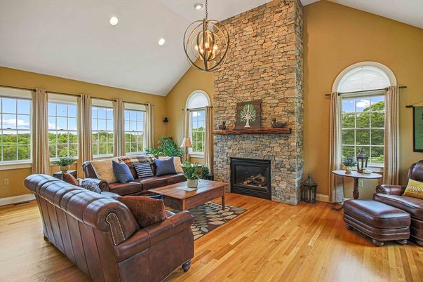 Chandelier, Fireplace, Interior, Living room, Recessed Lighting, Stone Walls, Wood Texture Flooring