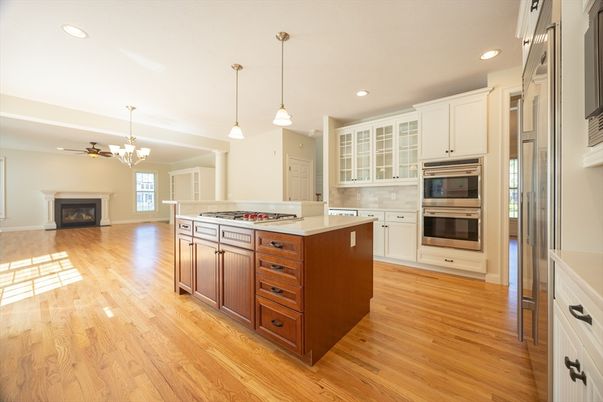 Chandelier, Fireplace, Interior, Kitchen, Pendant Lights, Recessed Lighting, Stainless Steel Appliances, Wood Texture Flooring