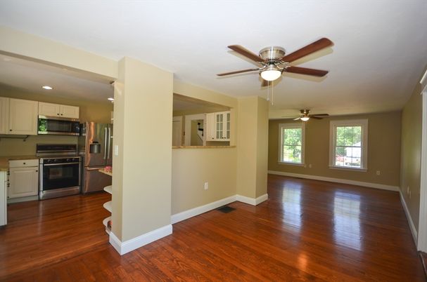 Empty room, Interior, Kitchen, Recessed Lighting, Stainless Steel Appliances, Wood Texture Flooring